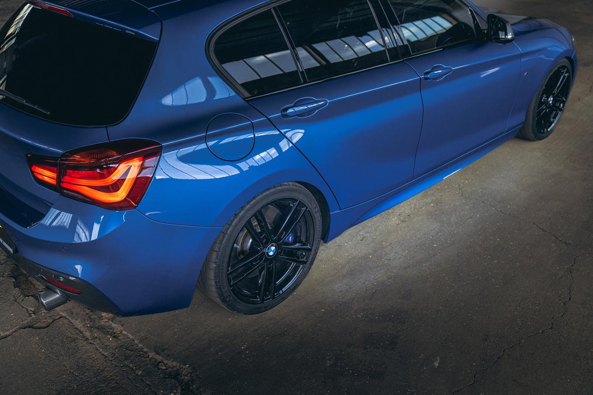 ST Suspension coilovers installed on BMW F20 M140i, showing adjustable shock absorbers and sporty suspension setup.