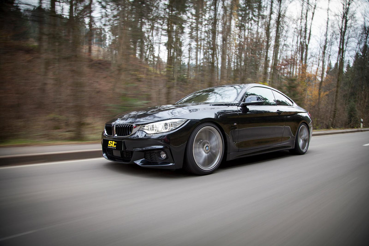 ST Suspension coilovers installed on BMW 4 Series F32, showing adjustable suspension components and sporty stance.