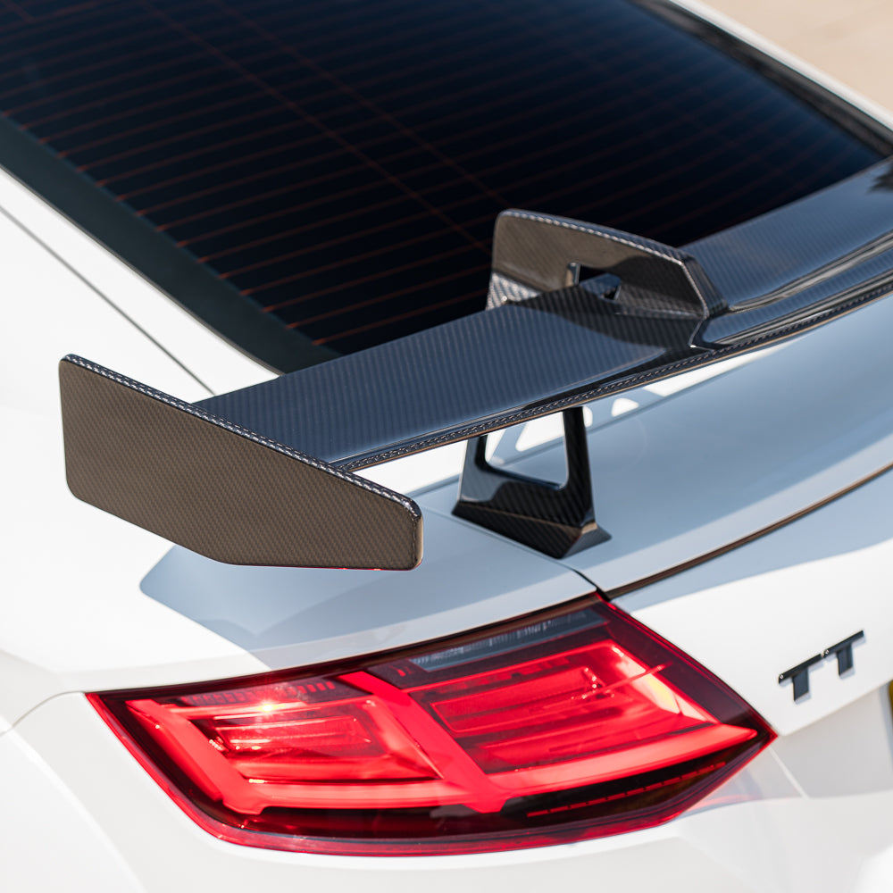 Carbon fiber wing spoiler for Audi TT/TTS/TTRS Quattro MK3, 2015-2020, by CT Carbon, shown from a side angle on the car.