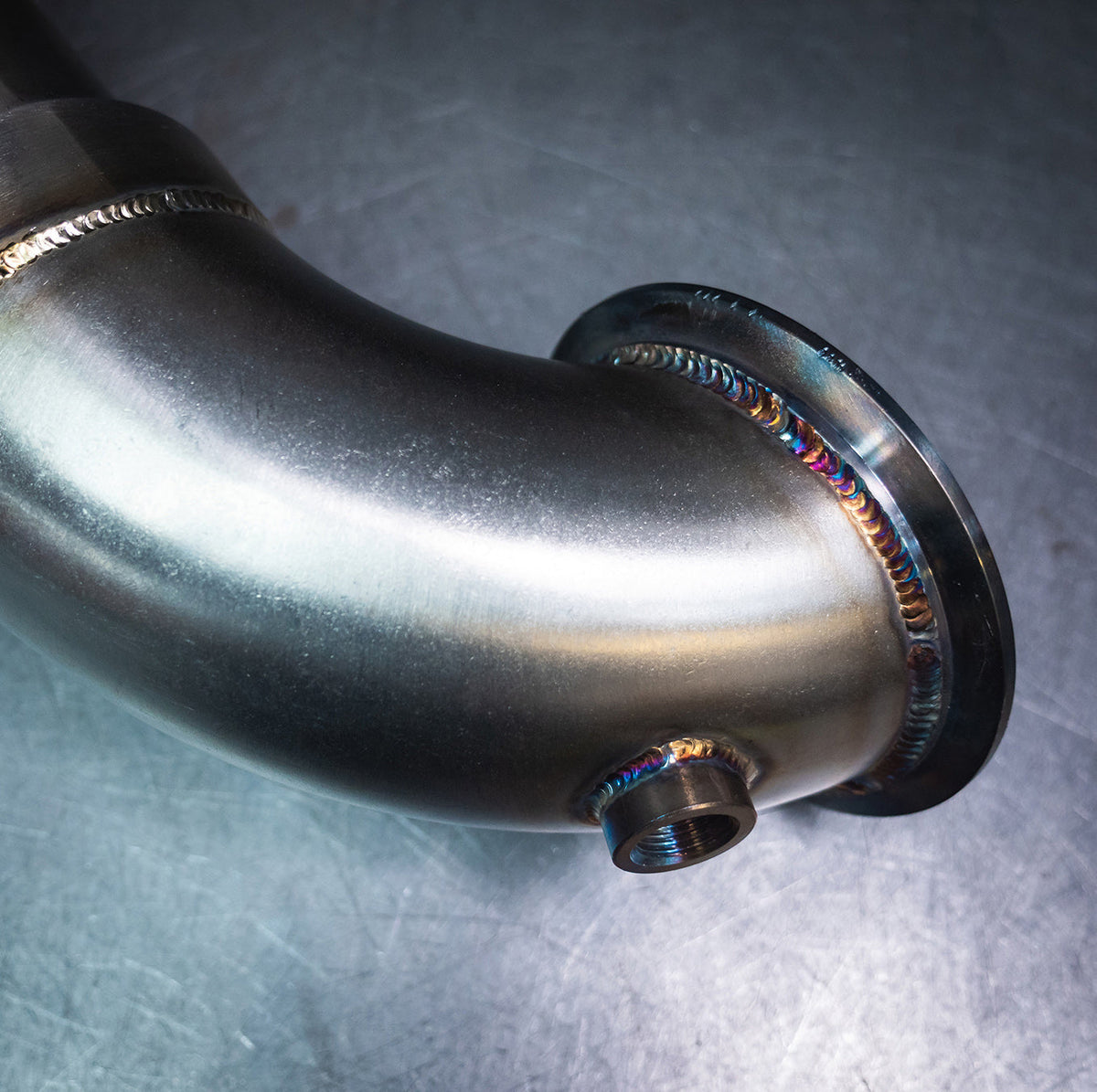 Cobra Sport VW Tiguan R 21+ front downpipe sports cat exhaust, showcasing the polished metal downpipe with Cobra Sport branding.