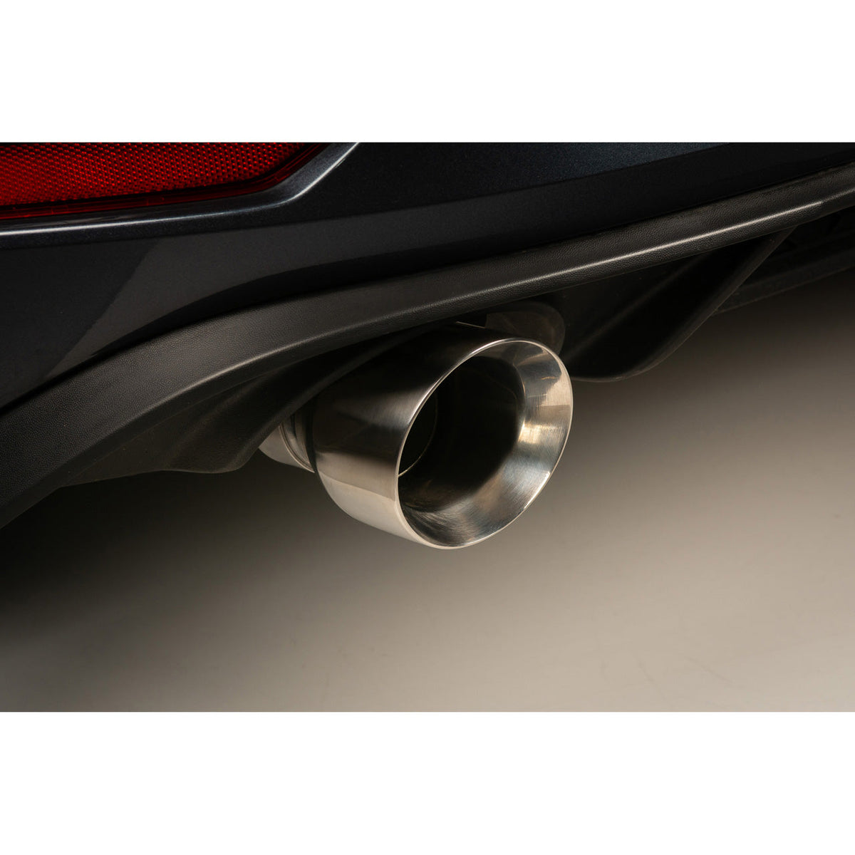 Cobra Sport VW Golf GTI MK7.5 2.0 TSI cat back performance exhaust system installed on the car's rear view.