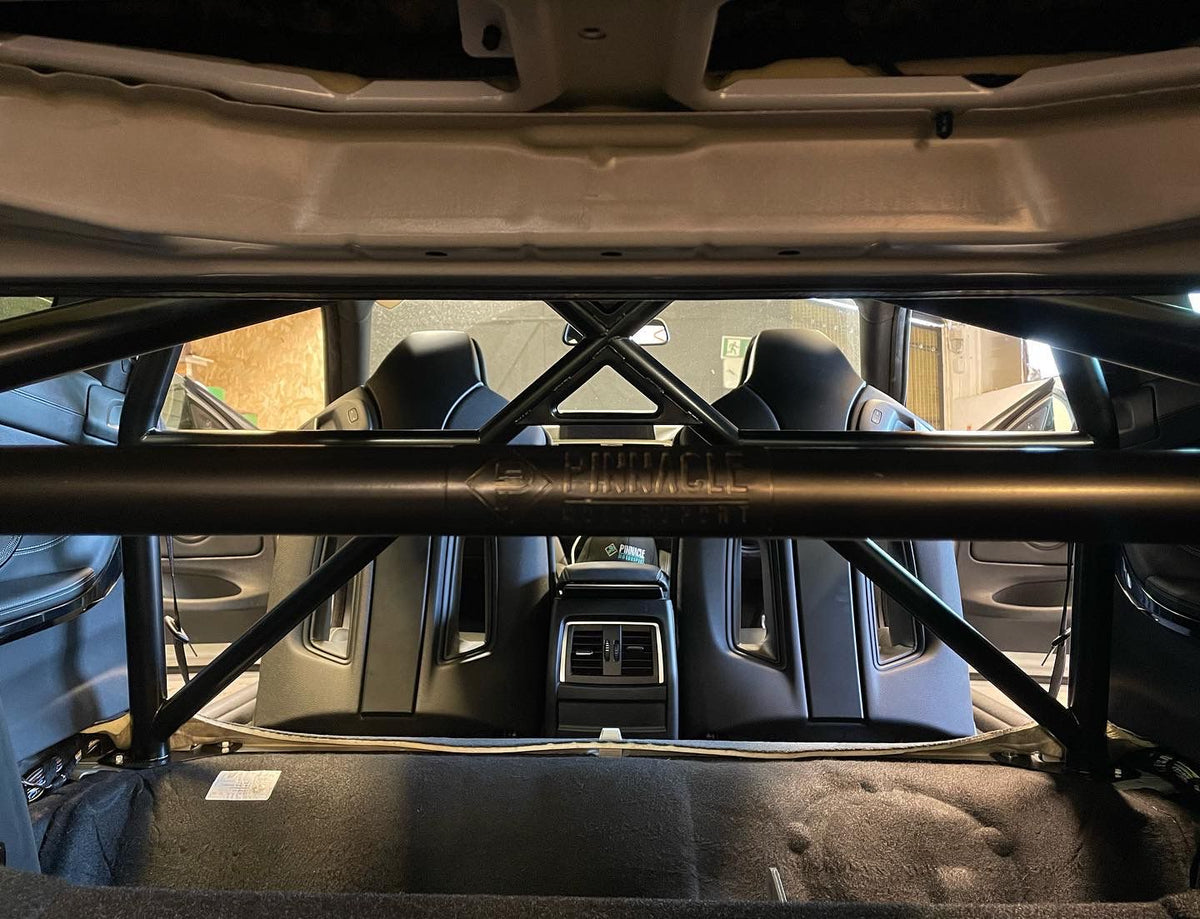 PINNACLE MOTORSPORT M4 GTS Style T45 Half Cage roll cage installed in a car interior with safety bars and mounting points visible.