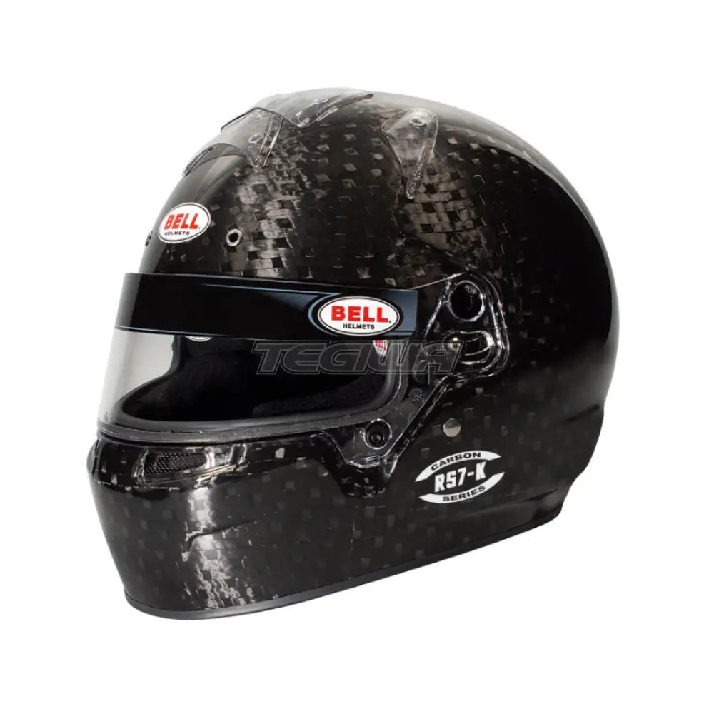 Bell RS7-K Carbon Karting Helmet showing its sleek black carbon fiber shell and clear visor for racing safety and style.