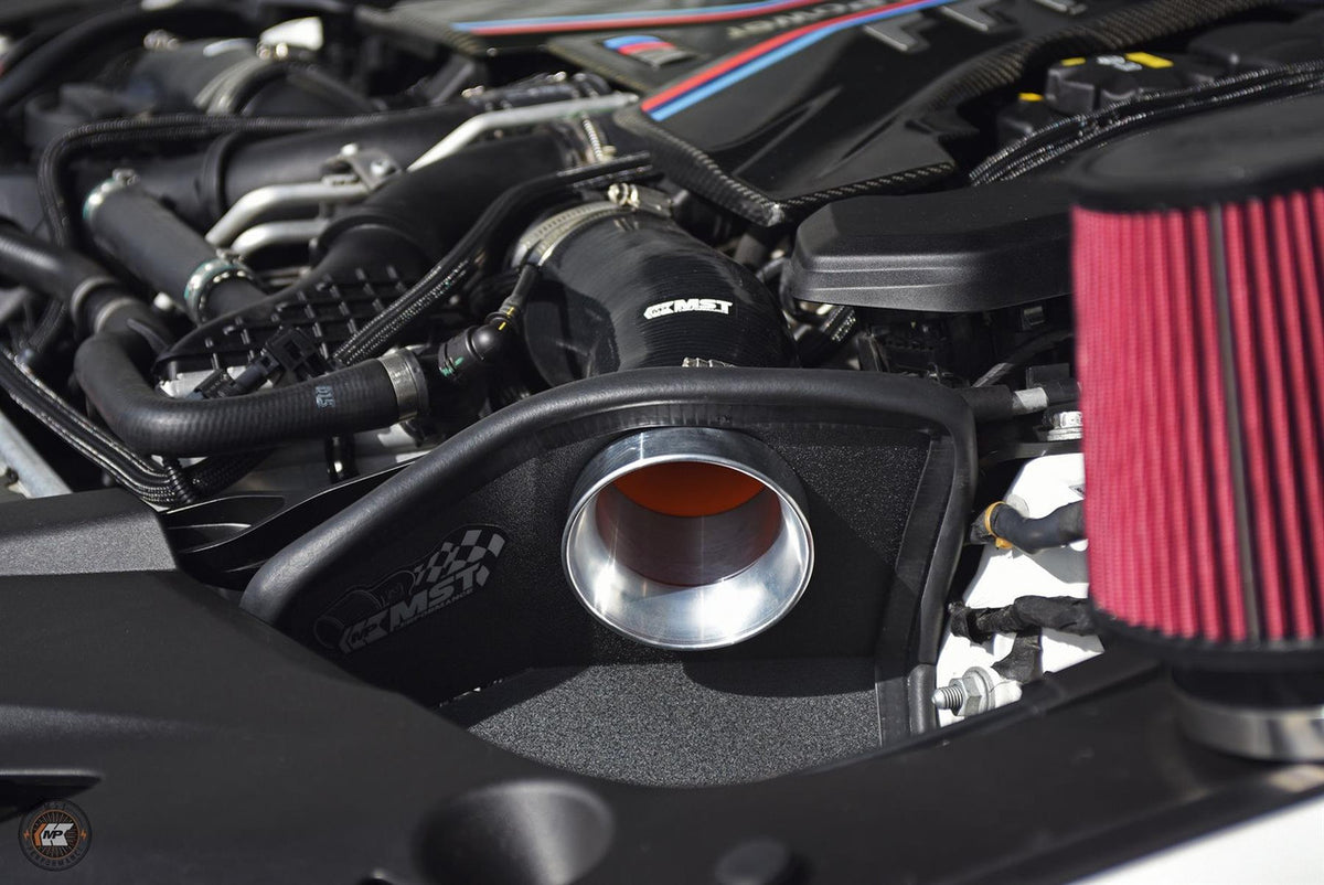 MST Performance induction kit for BMW M5 and M8 competition models, showcasing air intake components and brand logo.