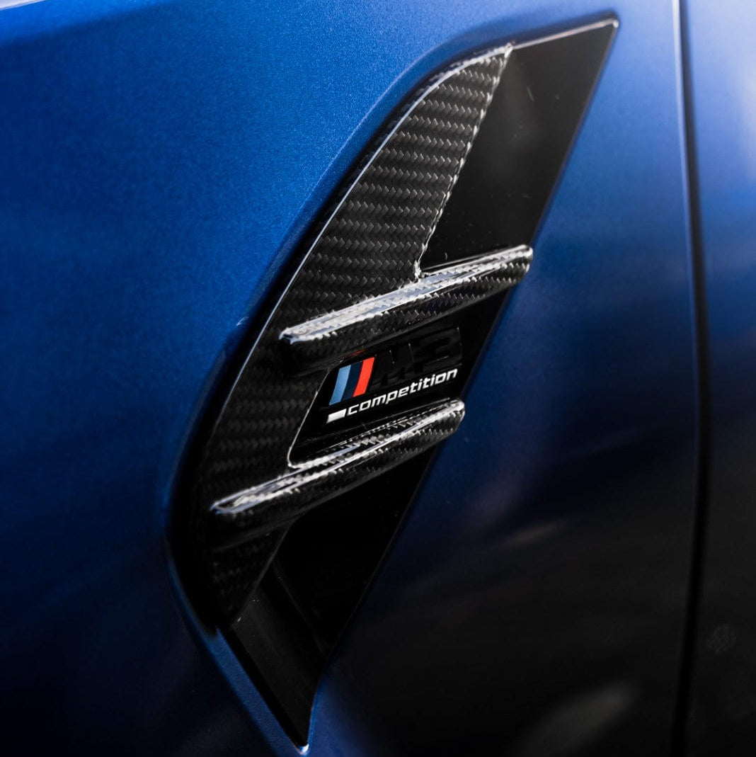 BMW M3 G80/G81 carbon fibre side fender trim by CT Carbon, showcasing sleek, lightweight accessory for enhanced vehicle styling.