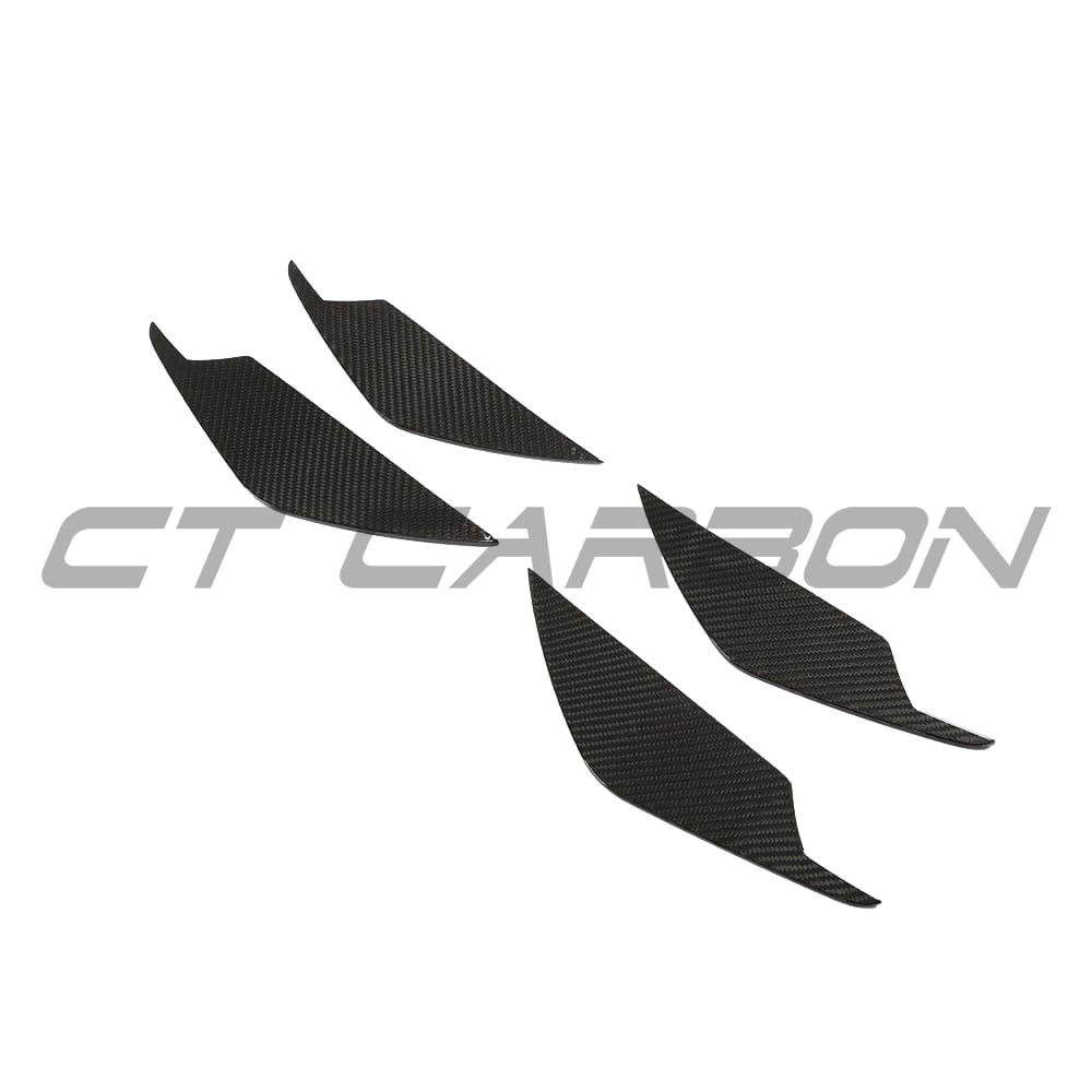 BMW M3 M4 G80 G82 G81 G83 carbon fibre front bumper canards by CT Carbon, showcasing aggressive aerodynamic accessories.