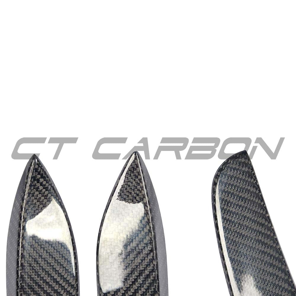 Carbon fiber front bumper canards for Mercedes W205 C63 and C63S, designed by CT Carbon, shown on the vehicle's front bumper.