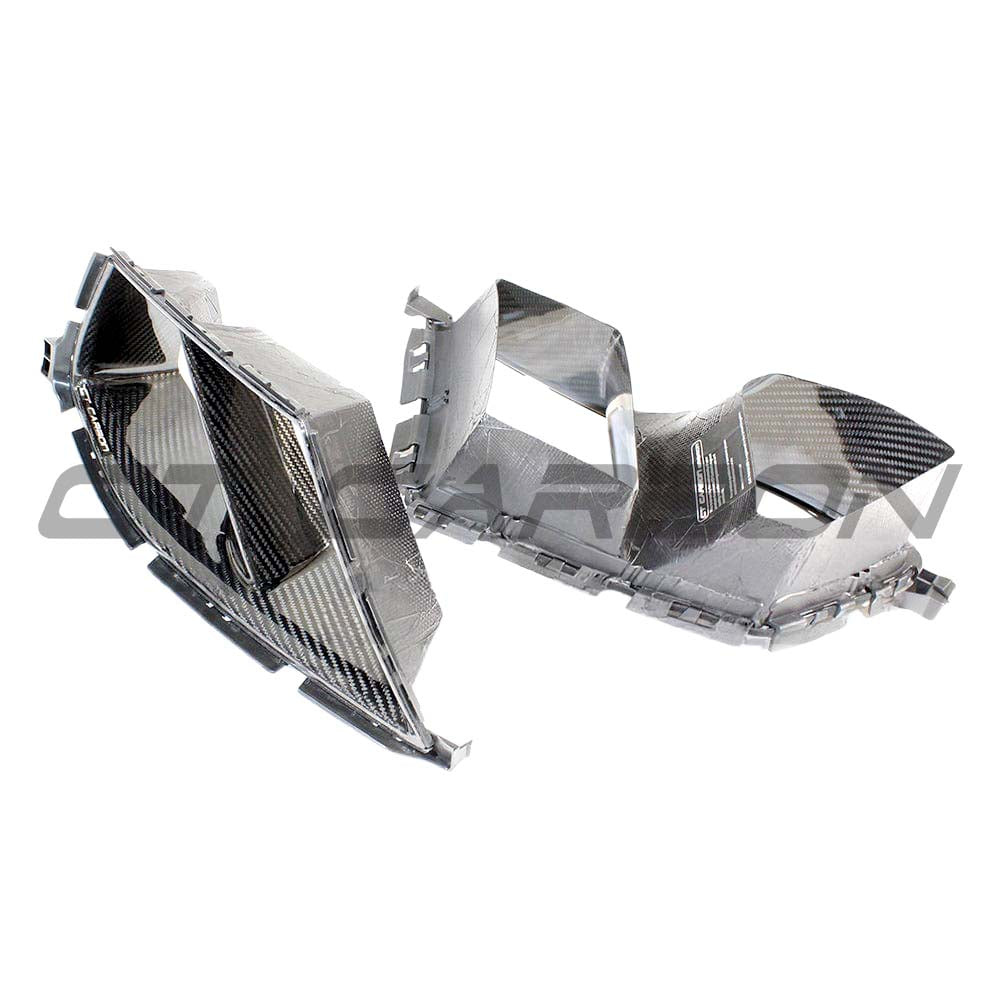 BMW M3 M4 G80 G82 carbon fibre bumper ducts by CT Carbon, showing sleek aerodynamic accessories with a textured carbon fiber finish.
