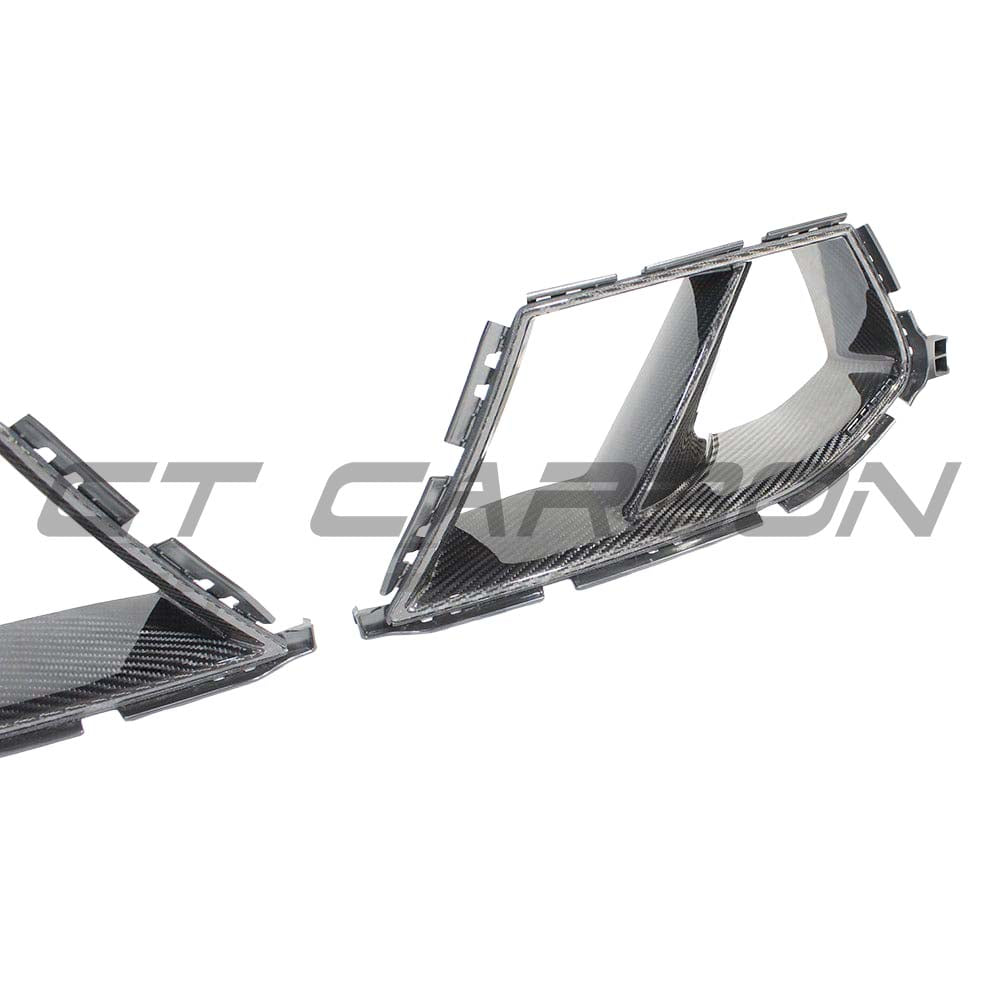 BMW M3/M4 G80/G82 carbon fibre bumper ducts by CT Carbon, showing sleek, lightweight aerodynamic accessories for sporty vehicle enhancement.