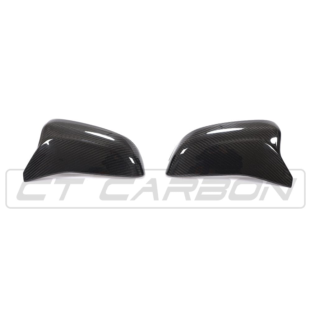 BMW F90 M5 M5C Competition carbon fiber mirror overlay by CT Carbon, RHD, showing sleek textured mirror cover on vehicle side.