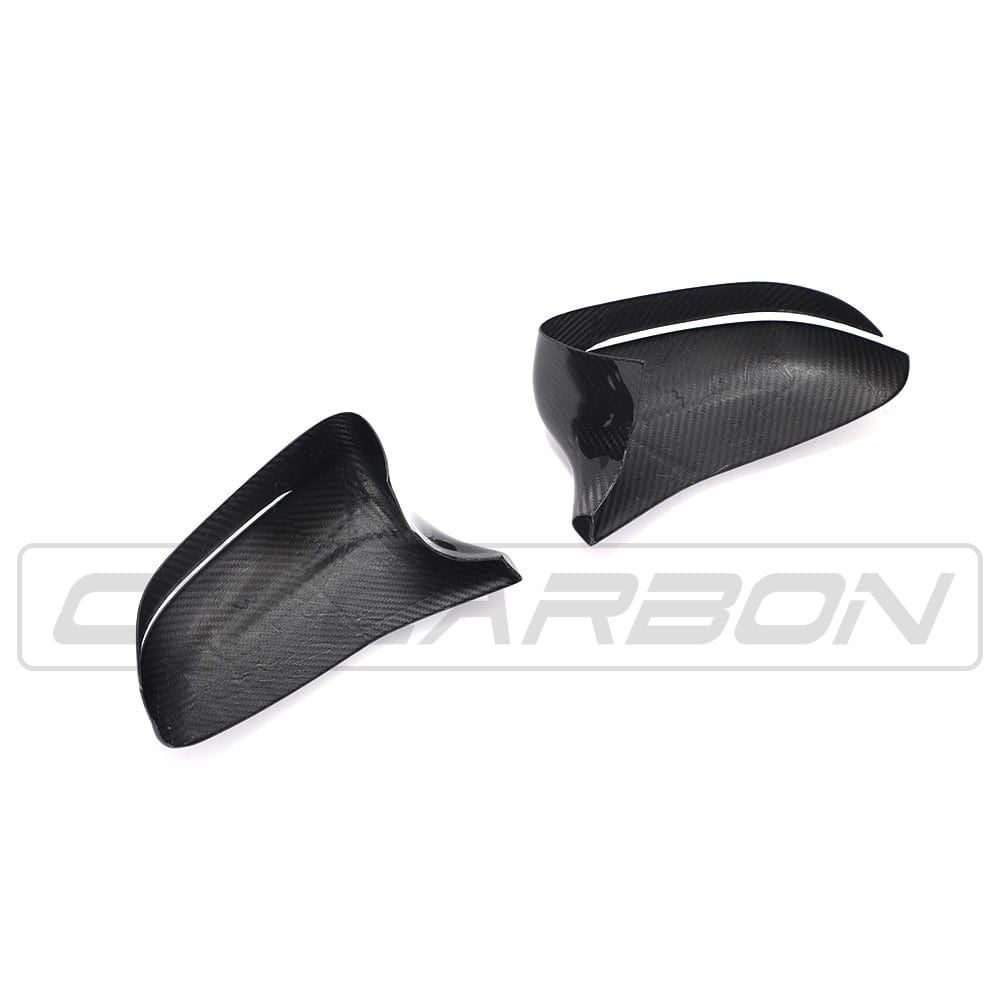 BMW F90 M5 and M5C Competition carbon fiber mirror overlay by CT Carbon, RHD side, showcasing sleek, textured carbon fiber surface.
