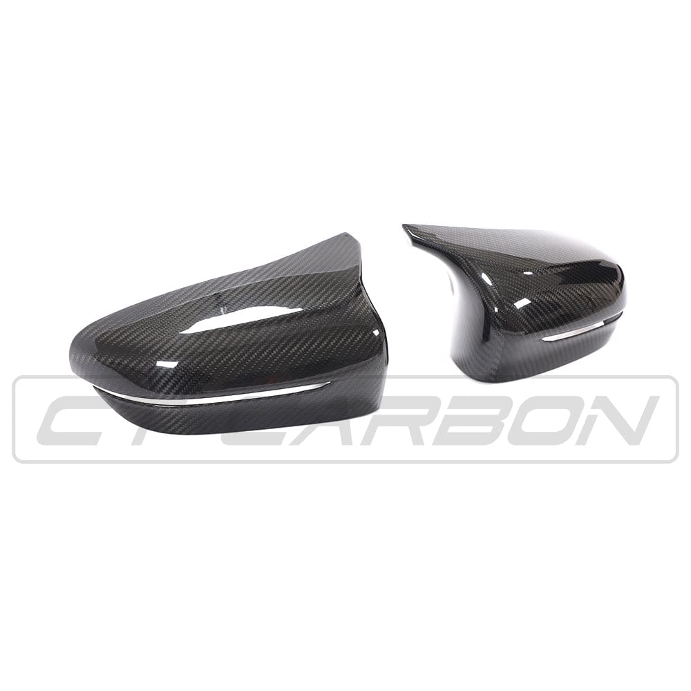 BMW F90 M5 Competition carbon fiber mirror overlay by CT Carbon, RHD side, showcasing sleek, textured mirror cover design.