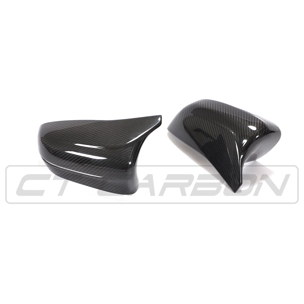BMW F90 M5 M5C Competition carbon fibre mirror overlay by CT Carbon, RHD, showing sleek matte black finish on side mirror.