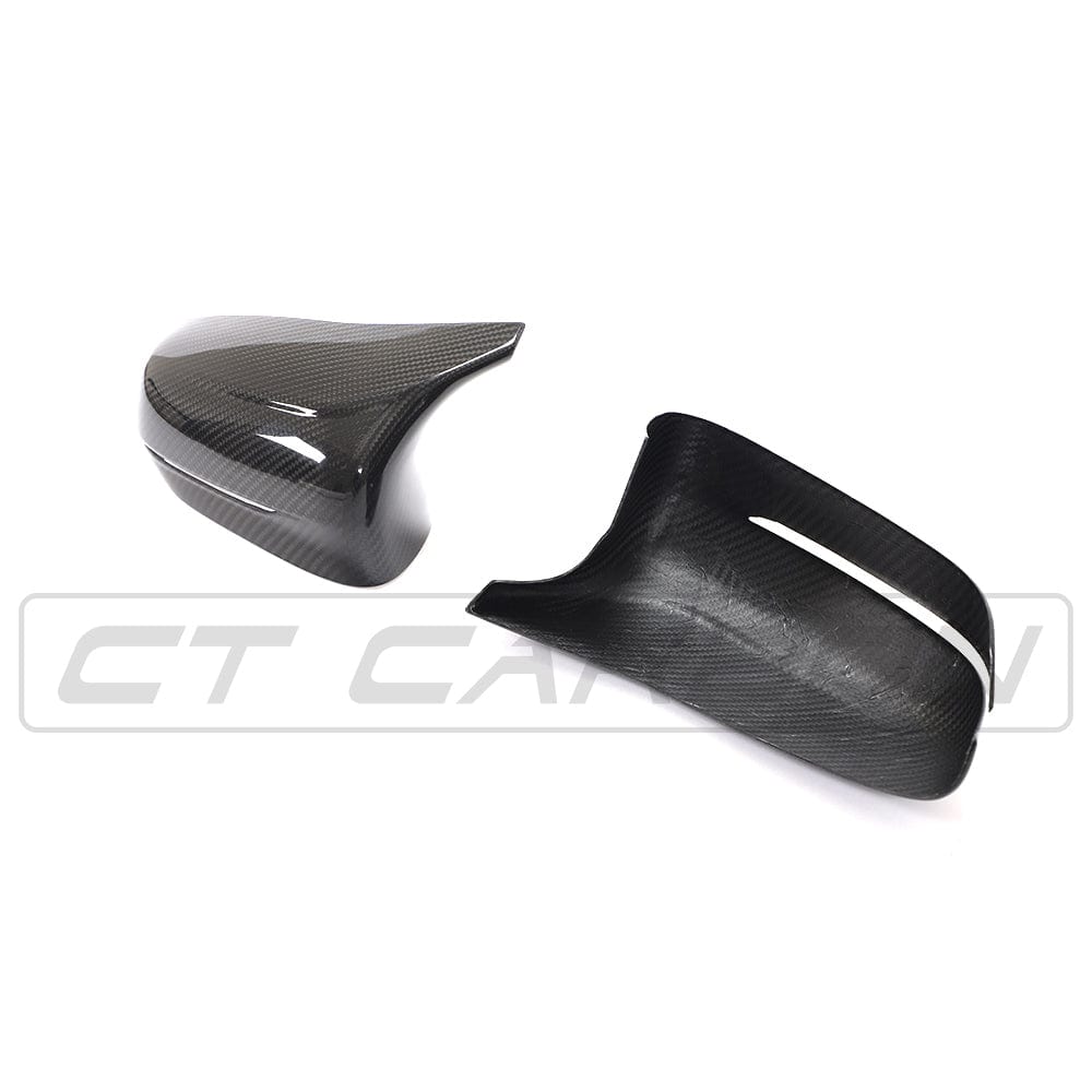 BMW F90 M5 M5C Competition carbon fibre mirror overlay by CT Carbon, RHD side, close-up of sleek carbon fibre textured mirror cover.