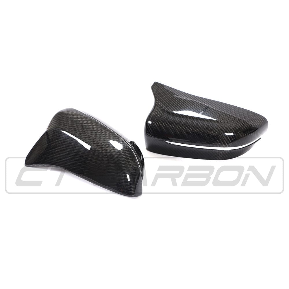 BMW F90 M5 M5C Competition carbon fibre mirror overlay by CT Carbon, RHD, showcasing sleek, textured mirror covers.