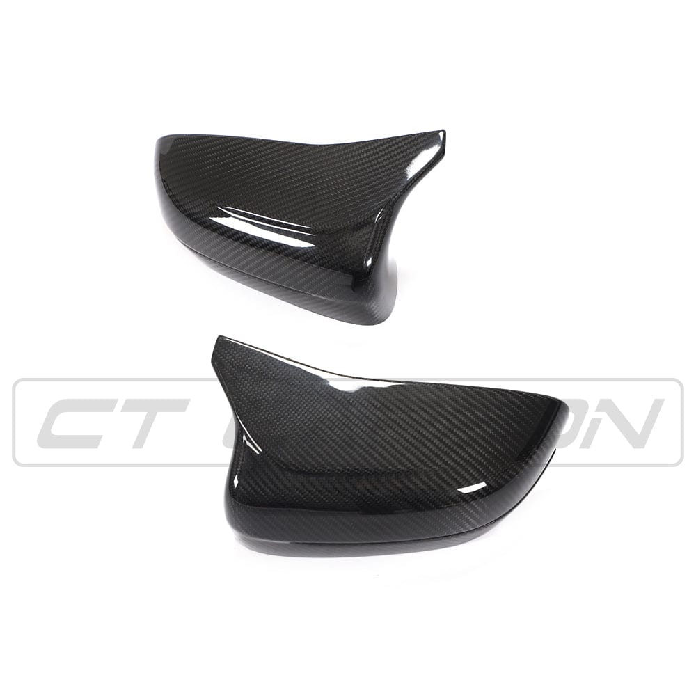 BMW F90 M5 and M5C Competition carbon fiber mirror overlay by CT Carbon, shown on the right-hand drive vehicle.