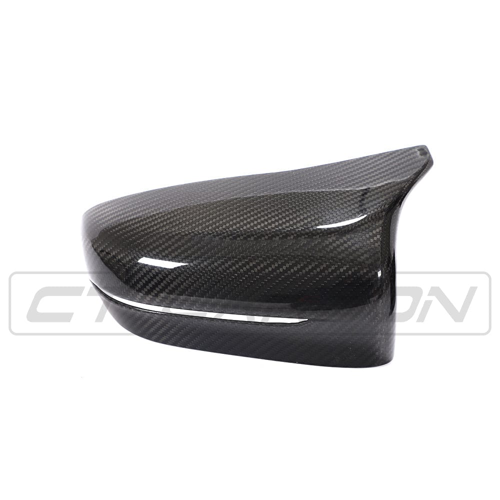 Carbon fiber mirror overlay for BMW F90 M5 M5C Competition, right-hand drive, by CT Carbon, shown on vehicle side mirror.