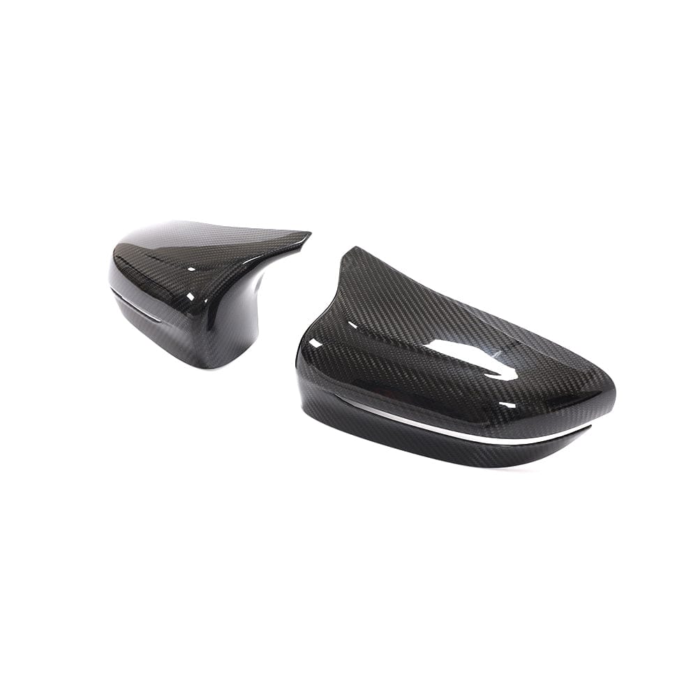 BMW F90 M5 M5C Competition carbon fibre mirror overlay by CT Carbon, showcasing sleek, textured carbon fibre surface on the side mirror.