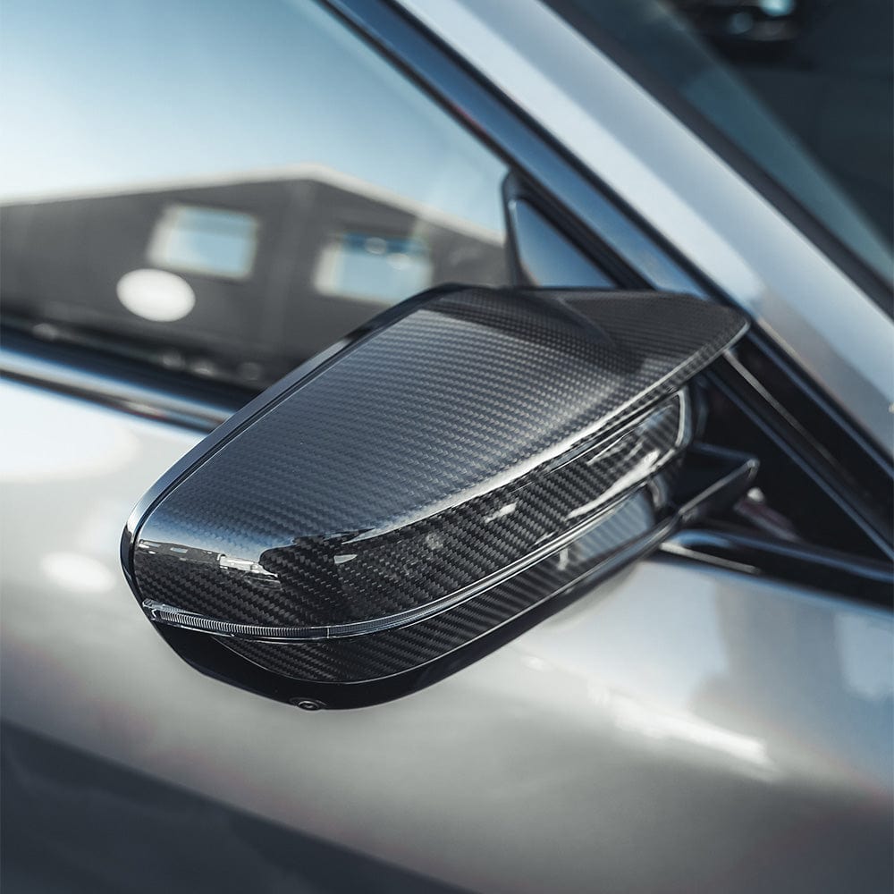 BMW M2 M3 M4 G80 G82 G83 G87 carbon fiber replacement mirrors by CT Carbon, right-hand drive, sleek aerodynamic design.