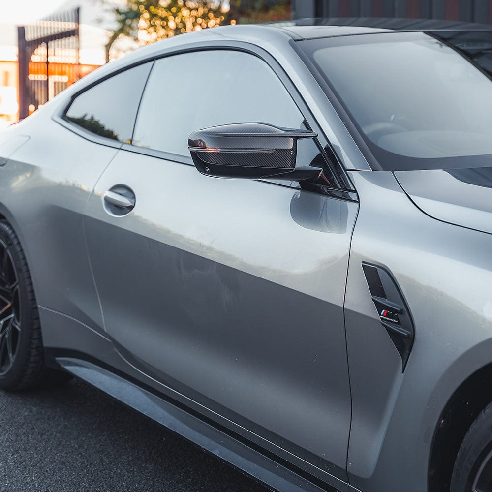 BMW M3 M4 G80 G82 G83 G87 carbon fibre replacement mirrors by CT Carbon, showing sleek, lightweight RHD side mirror accessories.
