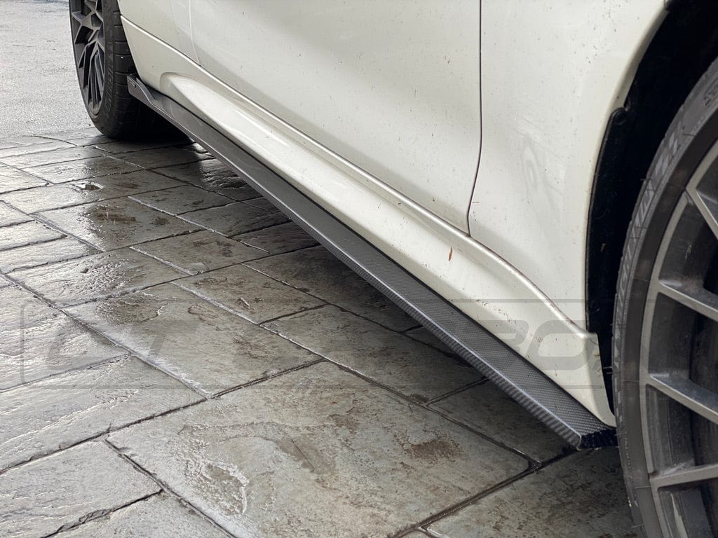 BMW M2 F87 carbon fibre side skirts by CT Carbon, featuring a sleek 3D design for enhanced aerodynamics and sporty style.