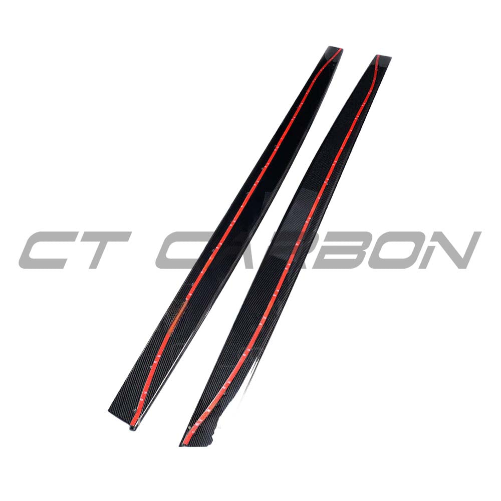 Full view of CT Carbon carbon fiber side skirts for BMW M3/M4 F80/F82/F83, showcasing sleek V-style design on a black BMW coupe.