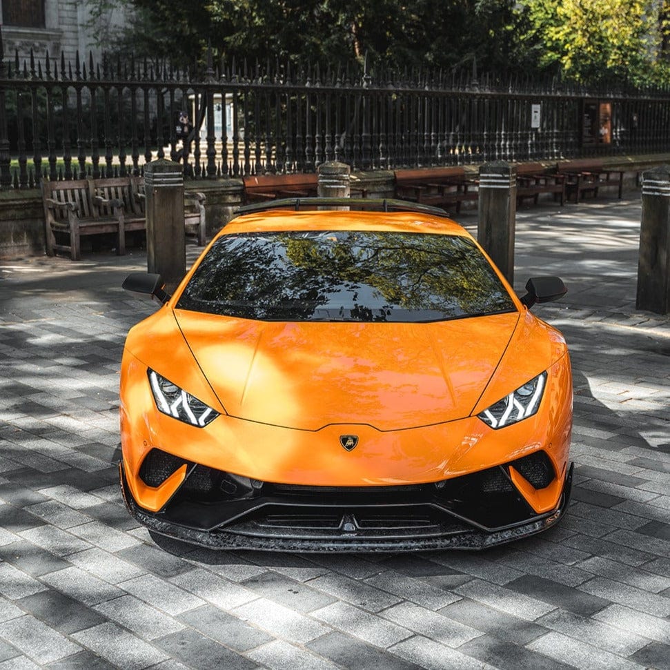CT Carbon Lamborghini Huracan Performante forged splitter, lightweight aerodynamic car part, mounted on front of bright yellow Huracan.