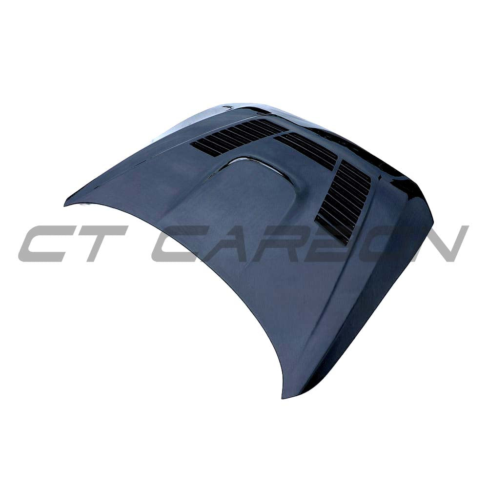 BMW F87 M2 carbon fiber bonnet from CT Carbon kit, showcasing lightweight, glossy black carbon fiber with detailed weave pattern.