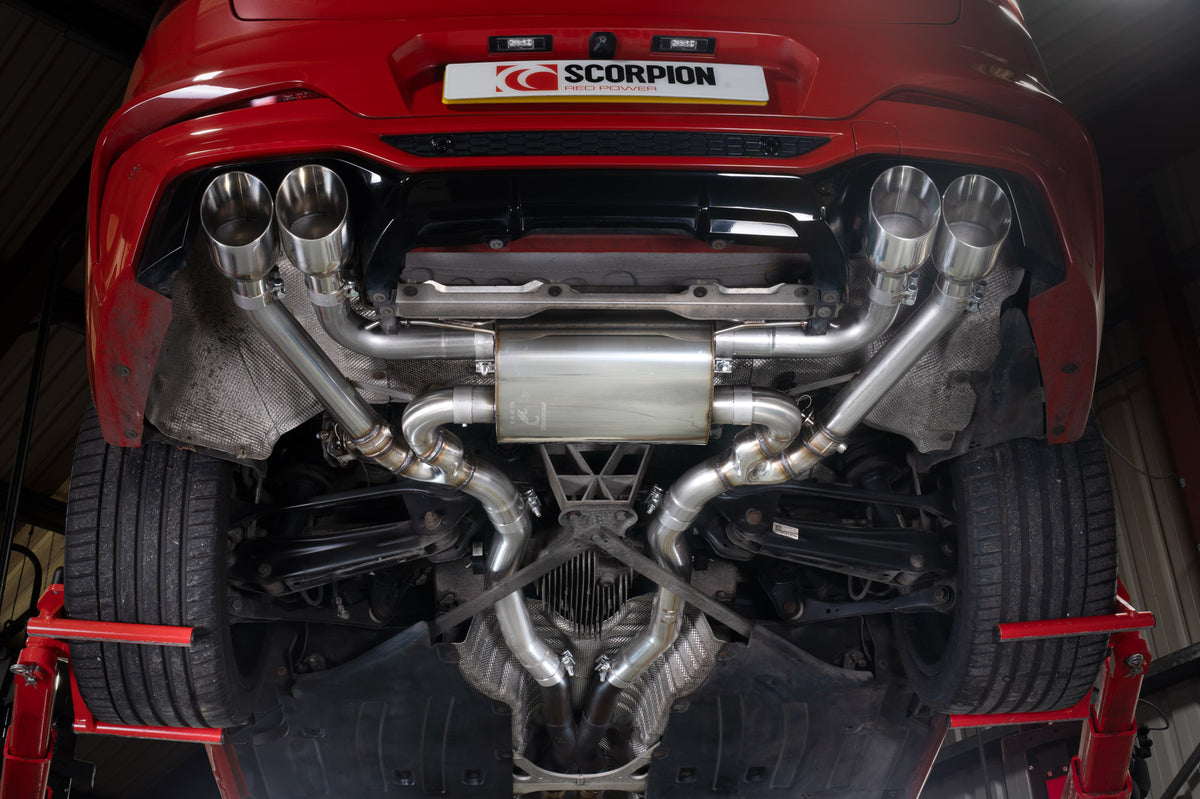 Scorpion BMW X4 M half exhaust system with valves and competition half system, black and chrome finish, installed on vehicle.