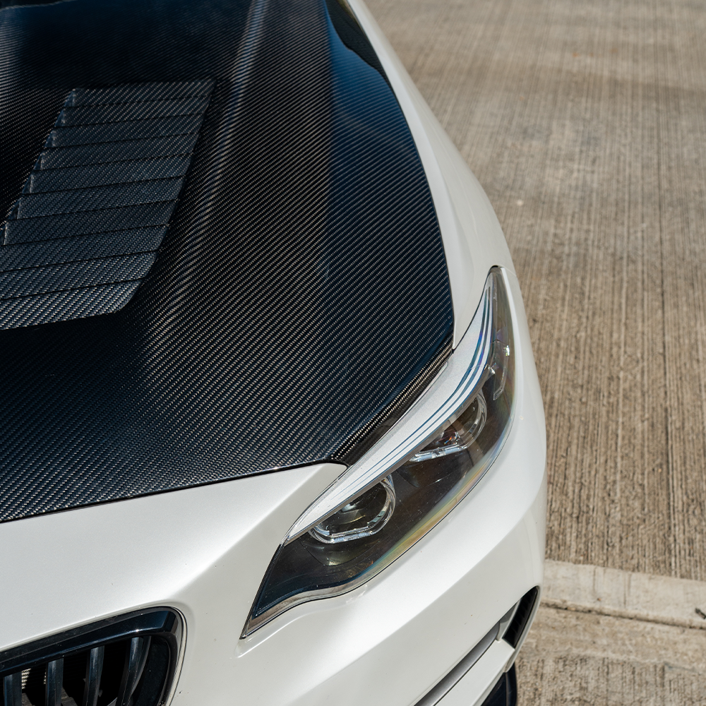 BMW M2 F87, M2C, 1 Series F20, 2 Series F22 carbon fibre bonnet by CT Carbon, showing close-up of lightweight hood design.