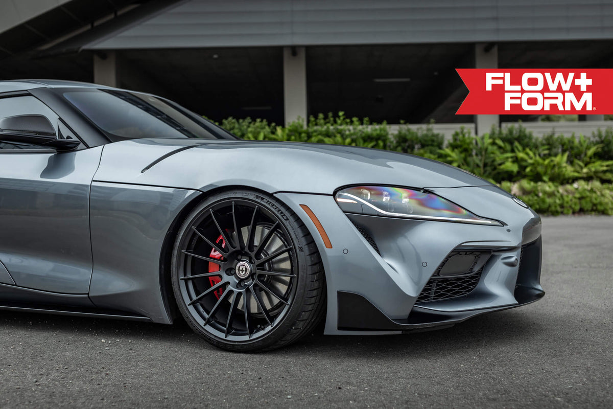 HRE PERFORMANCE WHEELS FF15 alloy wheels with a sleek multi-spoke design, shown on a car in a close-up view.