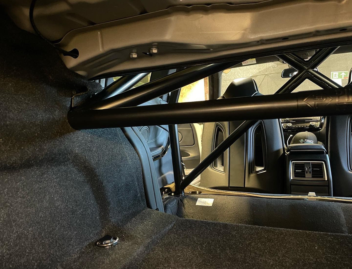 PINNACLE M4 GTS Style T45 Half Cage roll cage installed in a vehicle for enhanced safety and chassis reinforcement.