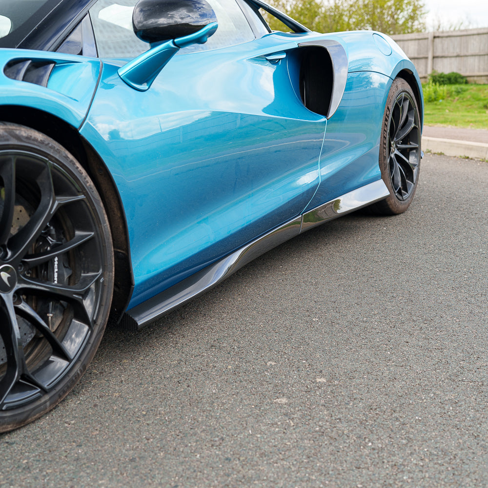 Carbon fiber side skirts for McLaren Artura 2023 by CT Carbon, shown installed on the vehicle's side.