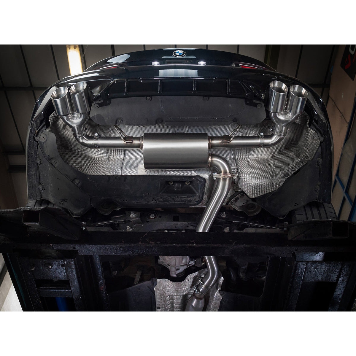BMW 320i G20 Cobra Sport quad exit non-valved M3 style performance exhaust installed on the vehicle.