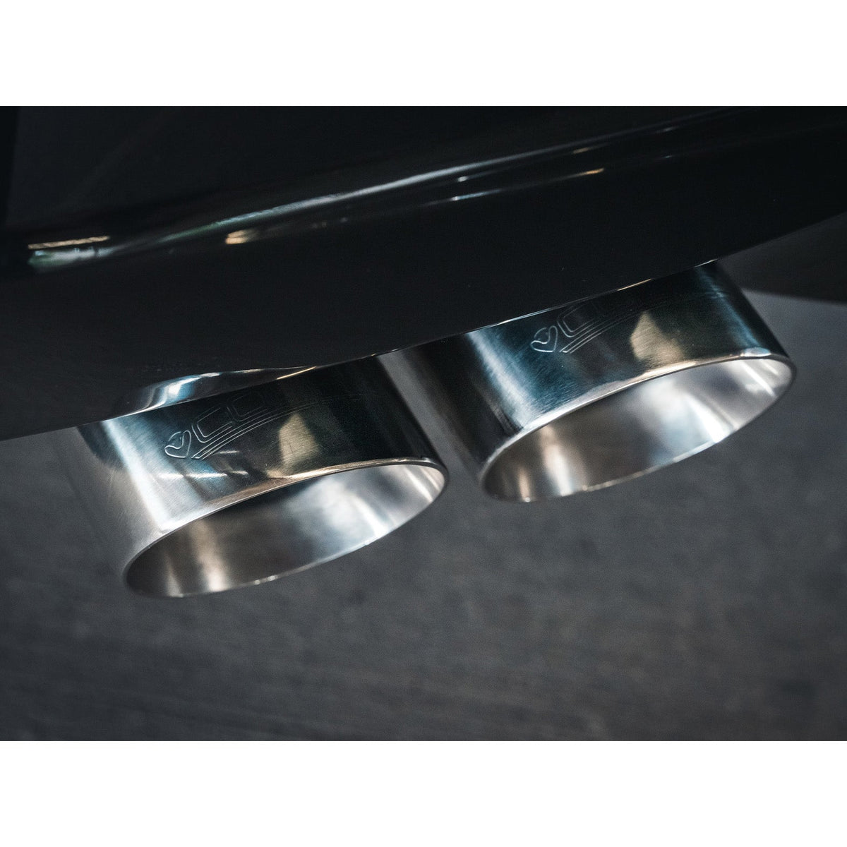 Cobra Sport BMW 320i G20 non-valved quad exit M3 style performance exhaust installed on a black BMW 320i G20.