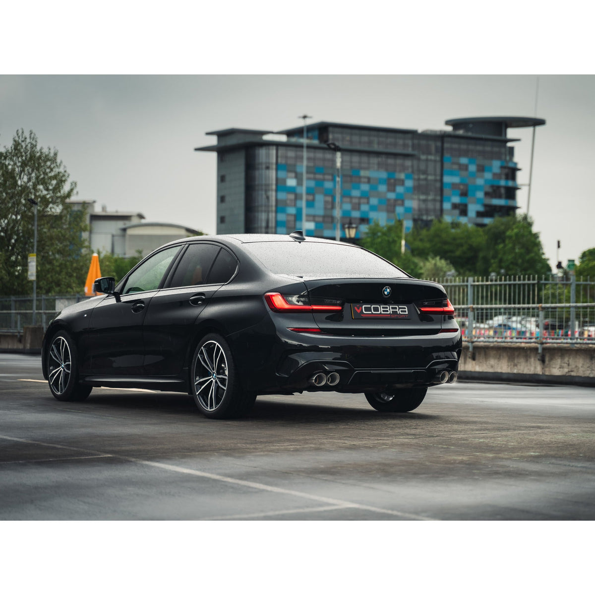 Cobra Sport BMW 320i G20 quad exit M3 style performance exhaust installed on vehicle, showcasing the non-valved quad exhaust system.
