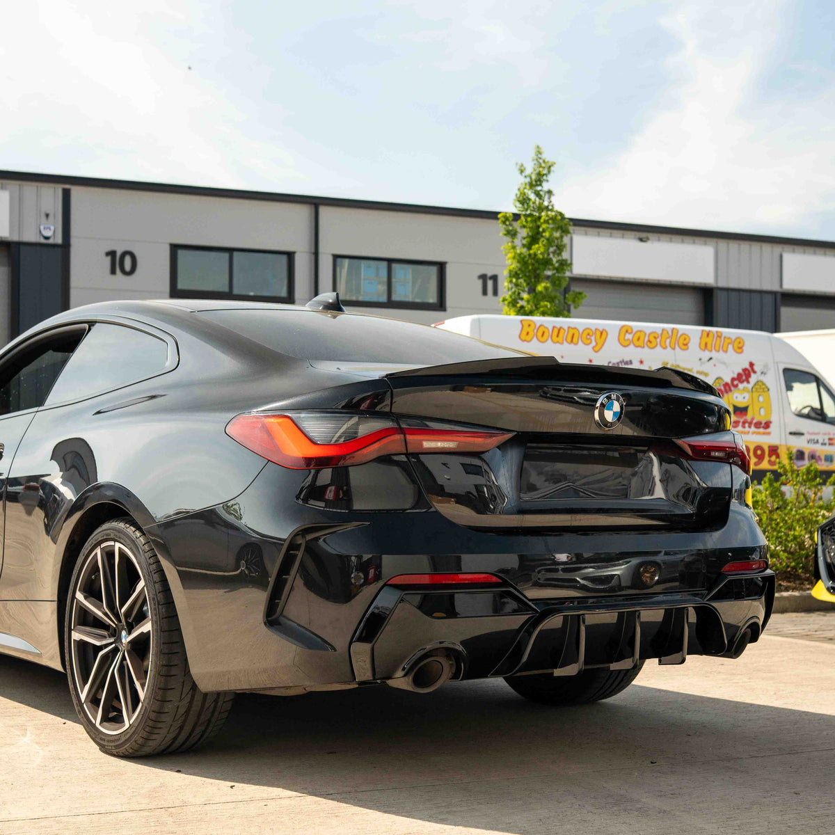 BMW G22 G23 4 Series 2020-2024 CT Carbon gloss black round tip diffuser installed on rear of vehicle.