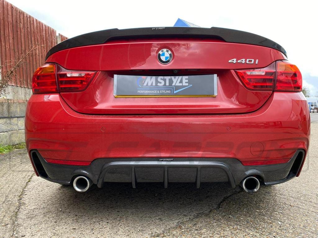 BMW F36 4 Series Coupe full carbon fiber kit by CT Carbon with dual exhaust, installed on the car showing sleek aerodynamic design.