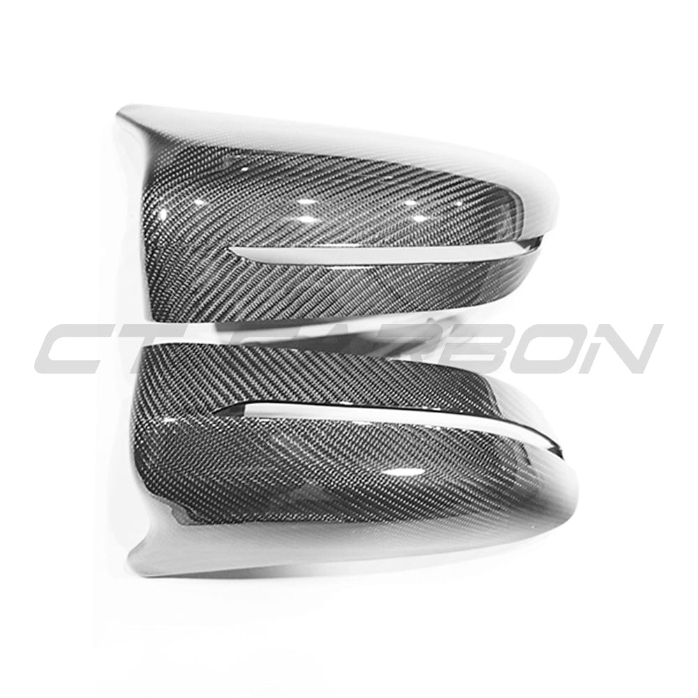 BMW F90 M5 Competition carbon fibre side mirrors by CT Carbon, LHD, showcasing sleek, lightweight mirror covers for sporty appearance.