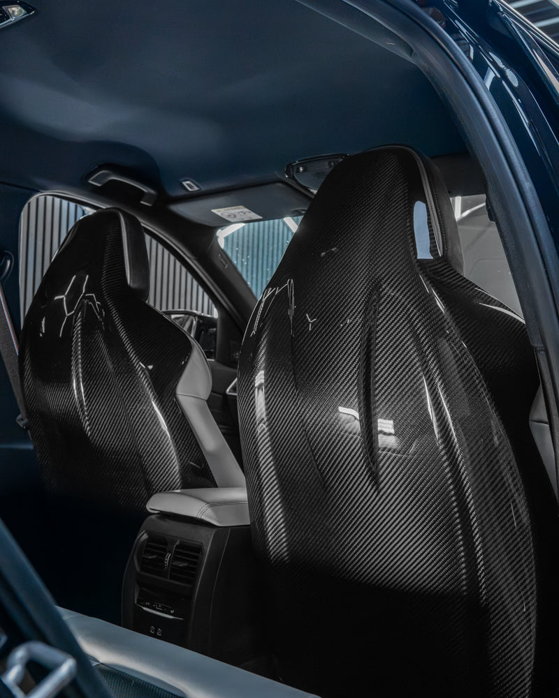 BMW GXX/F9X carbon fiber seat backs by CT Carbon, showcasing sleek, lightweight full carbon fiber exterior for a sporty look.