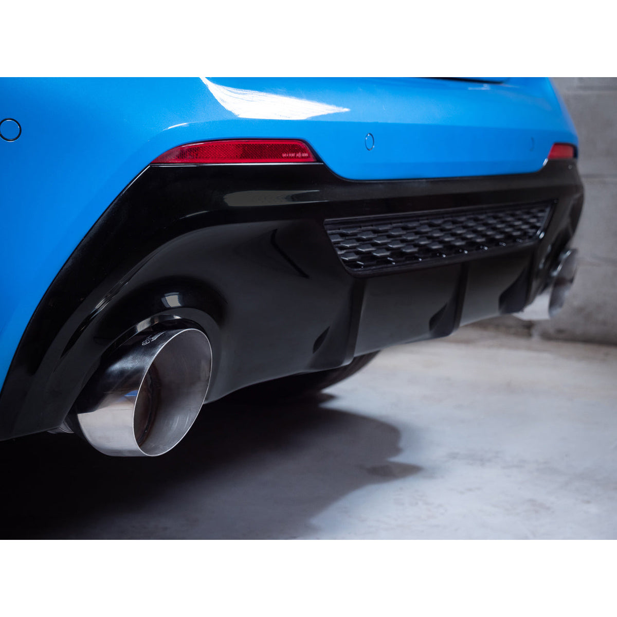 Cobra Sport BMW M135i F40 Venom Turbo Back Box Delete Race Performance Exhaust installed on the vehicle showing the exhaust tips.