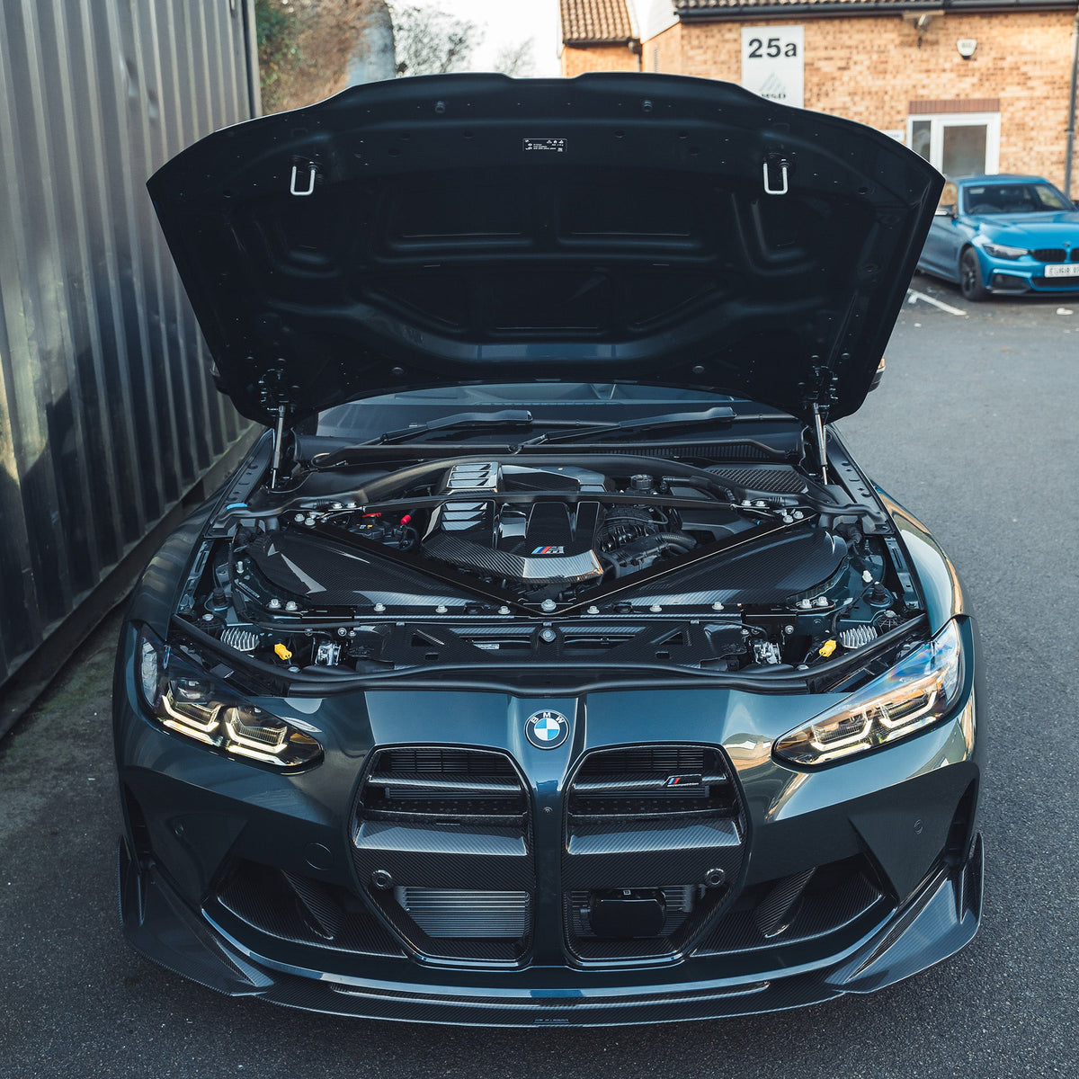 BMW G81 M3 Touring full carbon fiber engine dress-up kit by CT Carbon, featuring carbon fiber slam panel replacement.