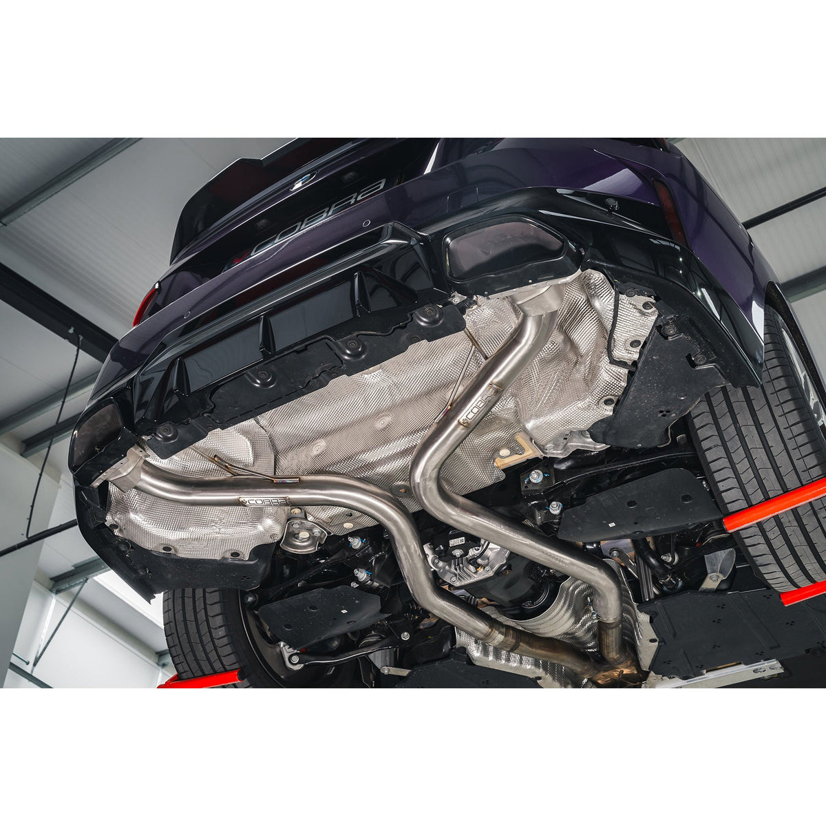 Cobra Sport BMW M240i G42 Venom Race rear axle back exhaust with back box delete, installed on the vehicle.