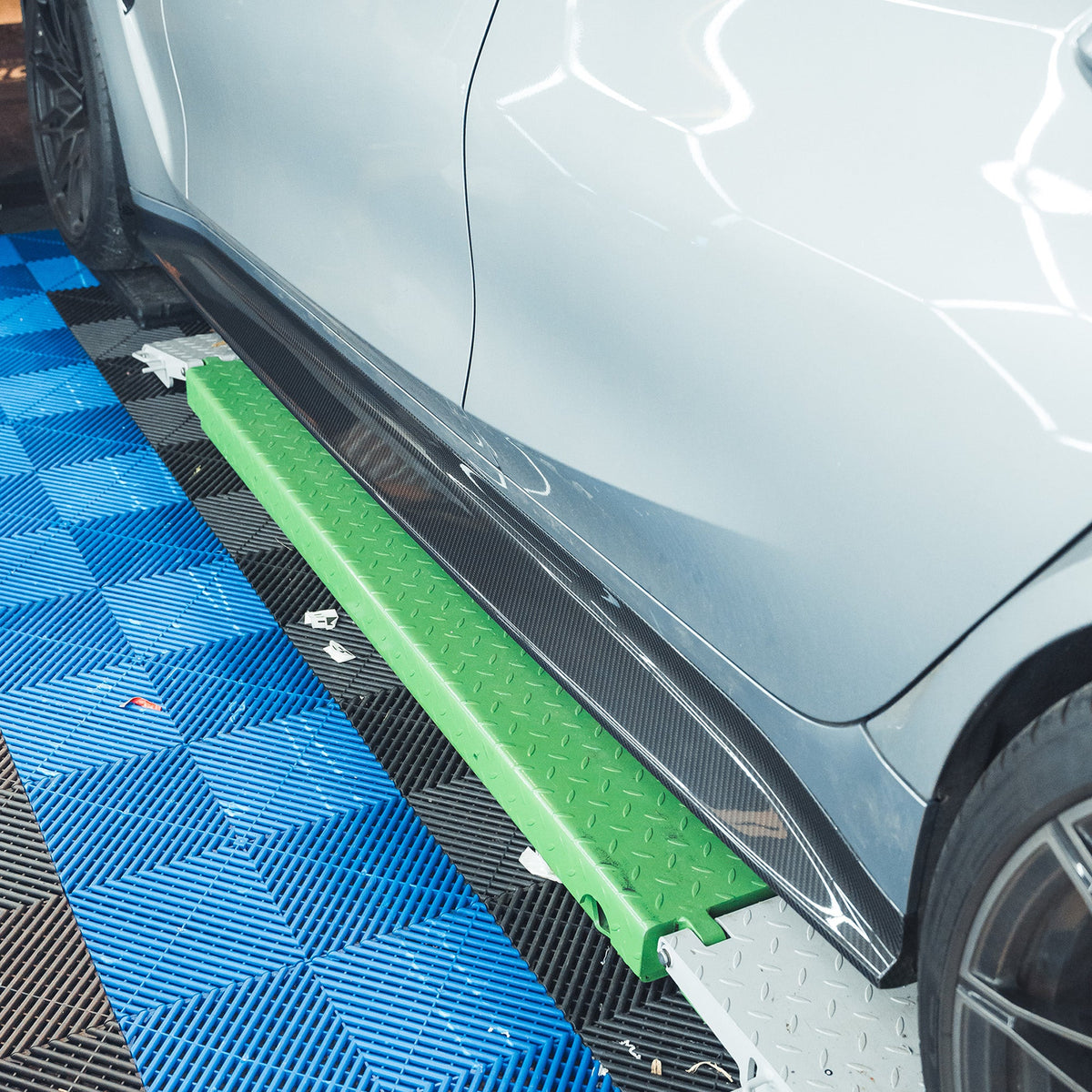 BMW M3 G80 G81 carbon fibre side skirt replacement by CT Carbon, showcasing the sleek, lightweight design and textured finish.