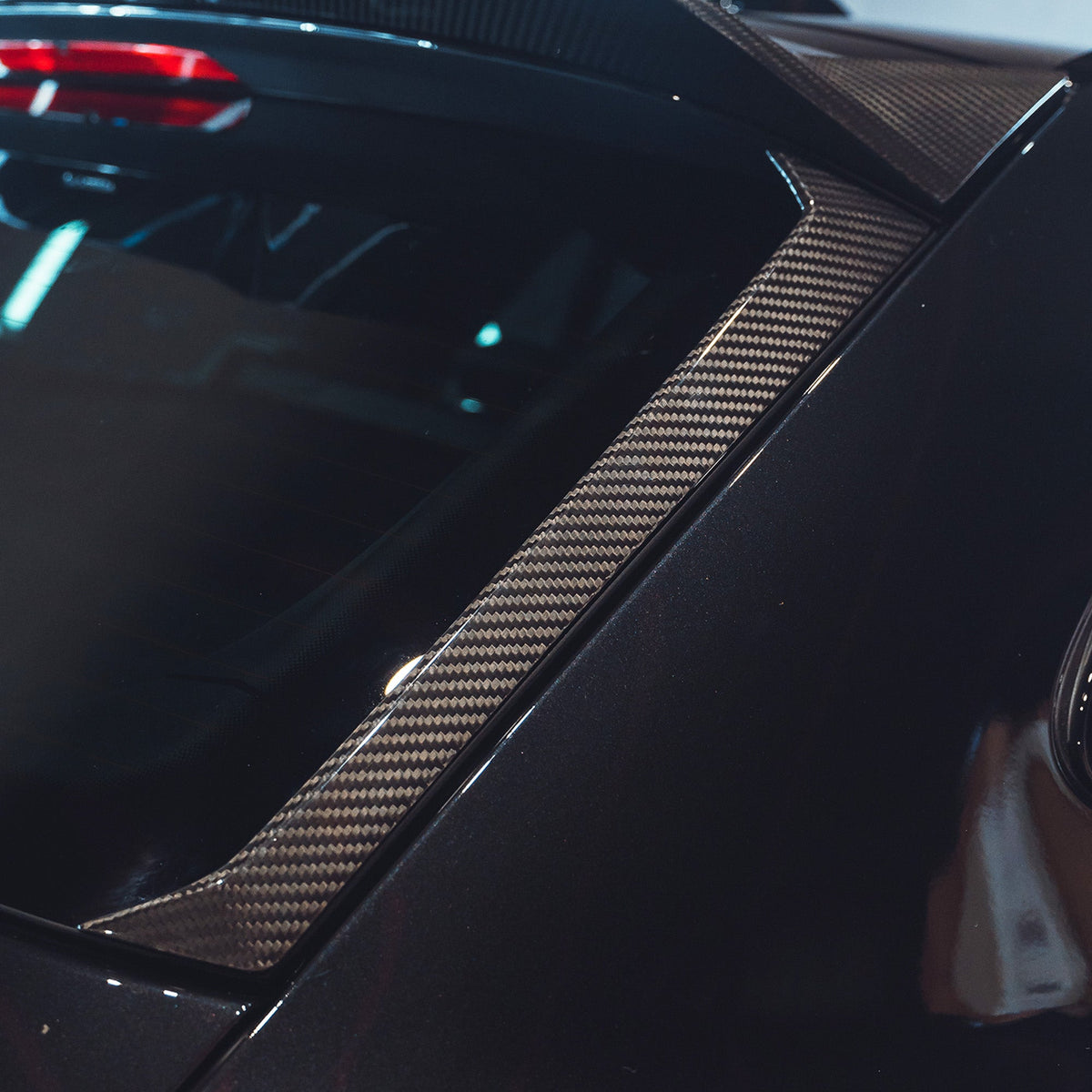 BMW M3 G81 carbon fibre spoiler by CT Carbon, front view showcasing sleek aerodynamic design on the car.
