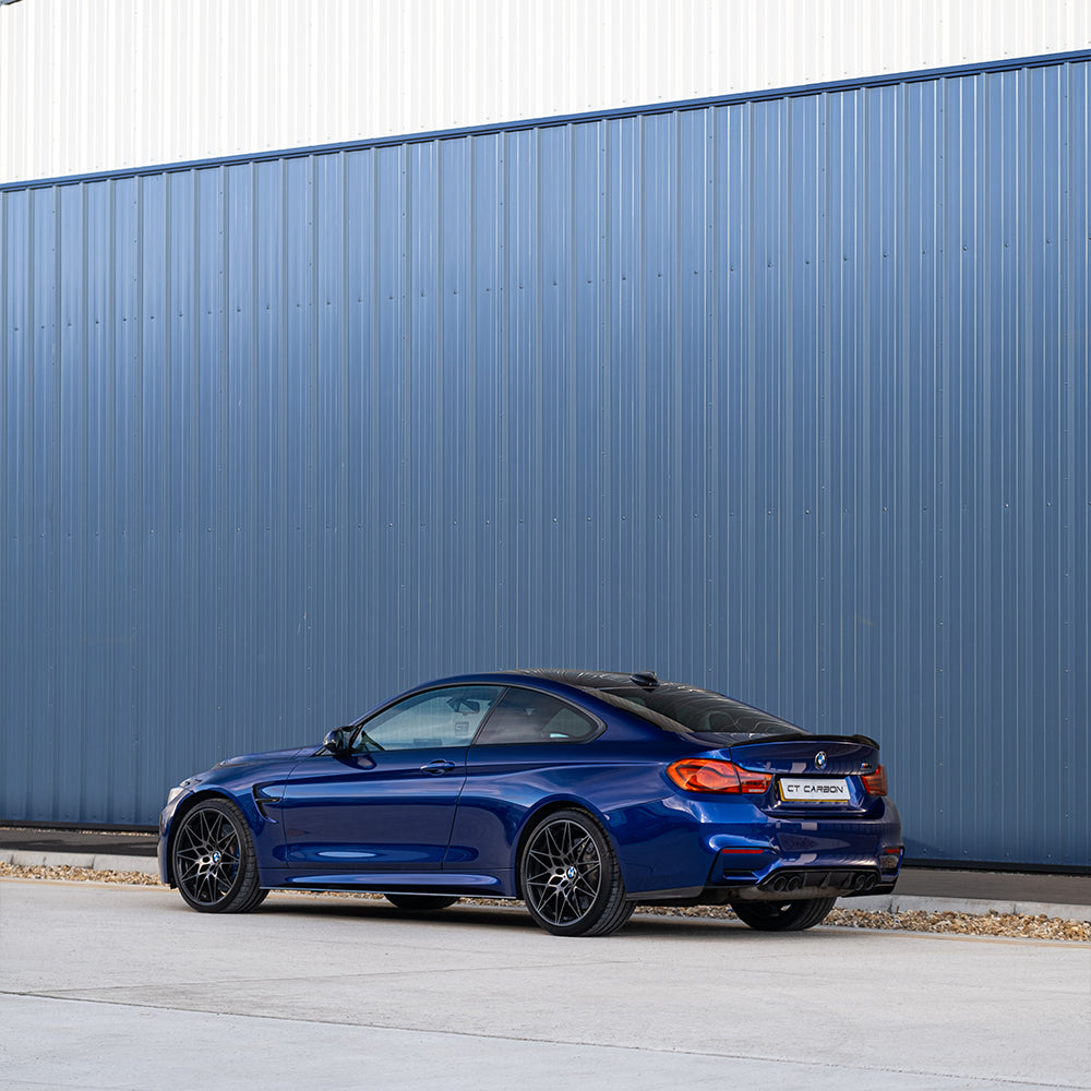BMW M3 M4 F80 F82 F83 carbon fiber rear bumper corners accessory by CT Carbon, showcasing sleek black finish on the car.