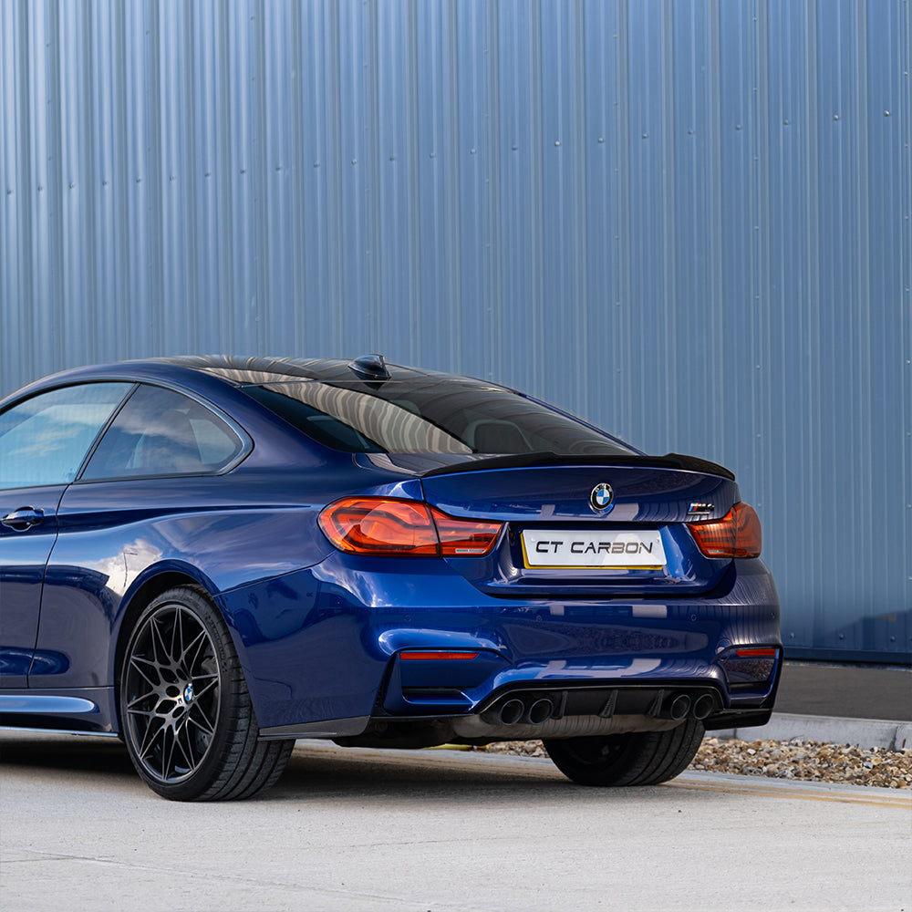 BMW M3 M4 F80 F82 F83 carbon fiber rear bumper corners accessory by CT Carbon, featuring a close-up view of the blue component.