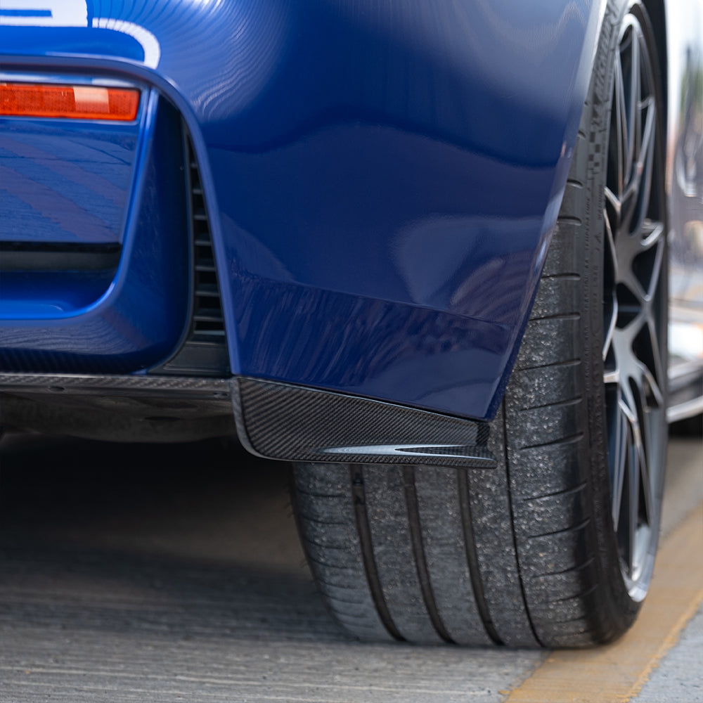 BMW M3 M4 F80 F82 F83 carbon fibre rear bumper corner accessories by CT Carbon, shown in blue with detailed fiber finish.