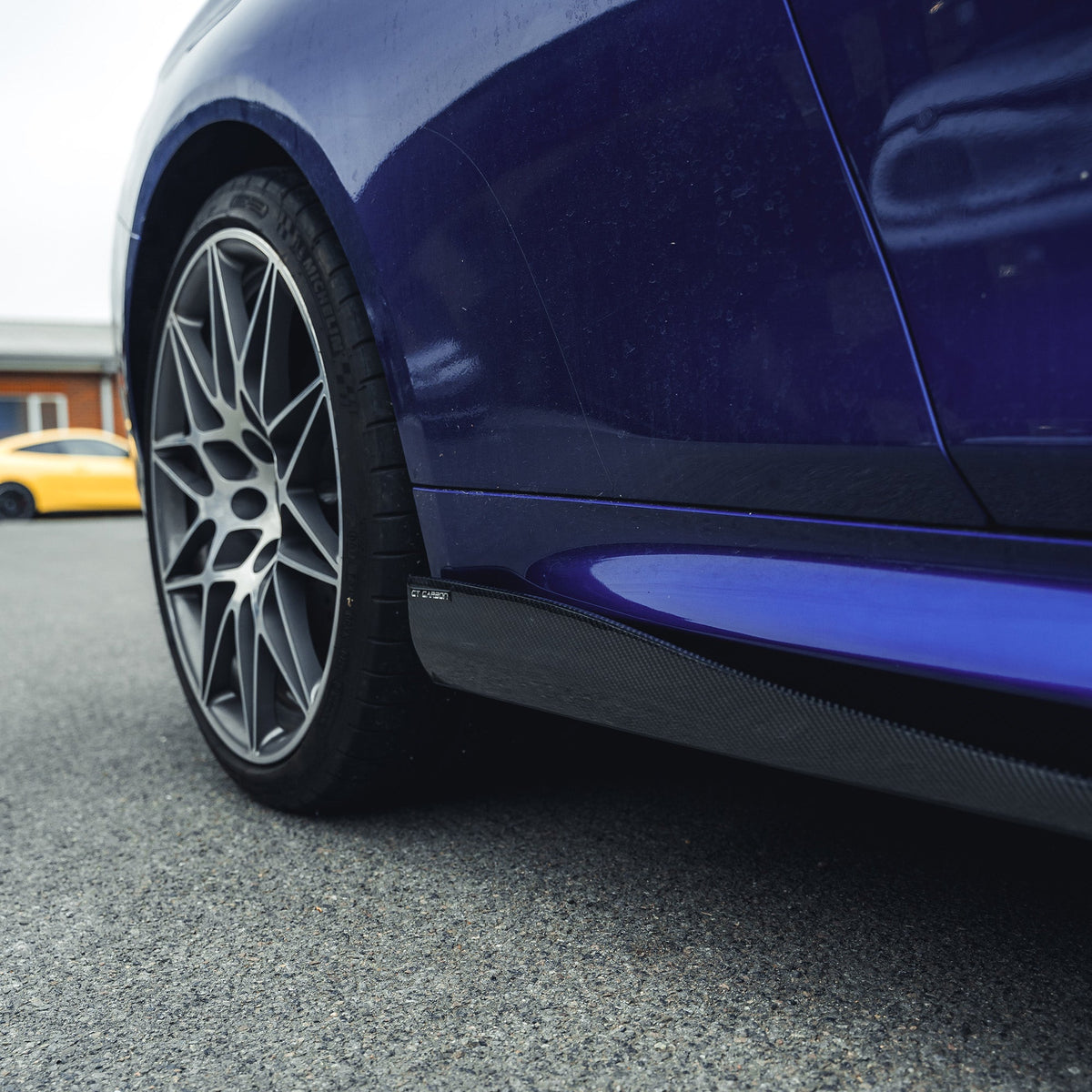 BMW M3 M4 F80 F82 F83 carbon fibre side skirts by CT Carbon, showing sleek aerodynamic design on a sports car.