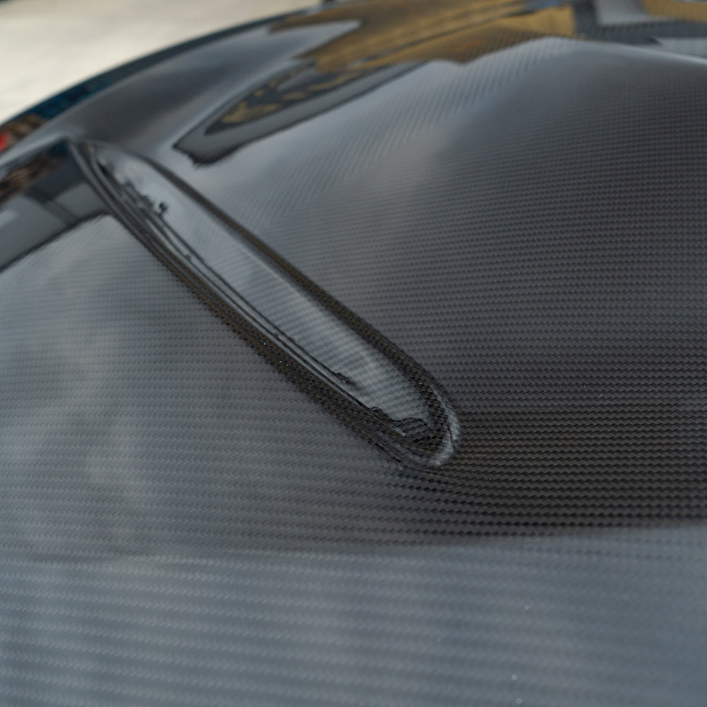 BMW M3/M4 F80 F82 F83 carbon fibre bonnet by CT Carbon, showing sleek, lightweight hood with textured carbon fiber pattern.